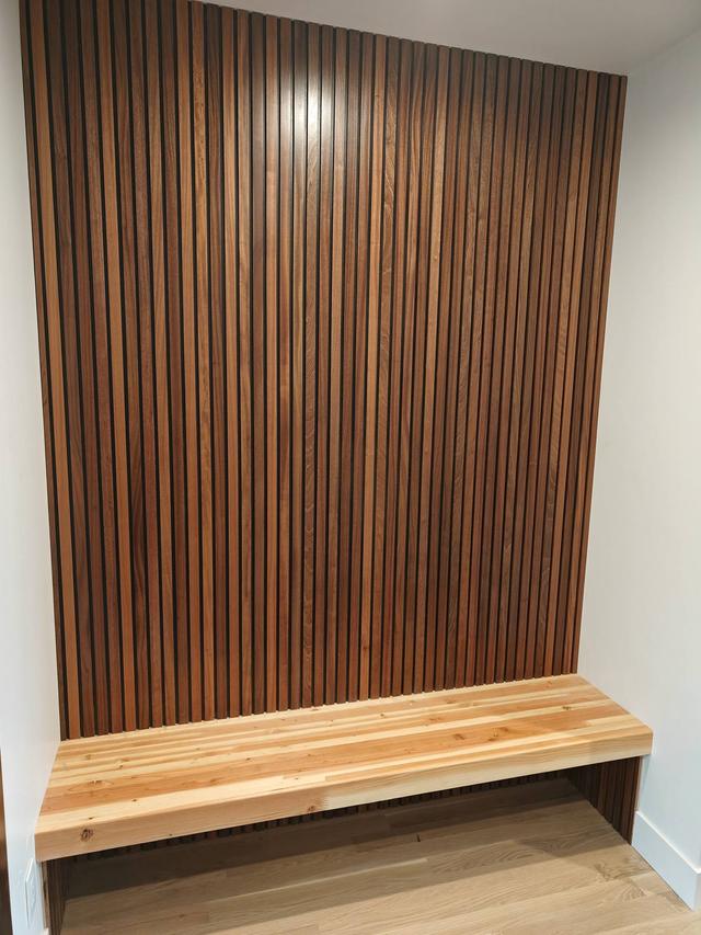 Custom sapele slat wall panel with built-in wood bench