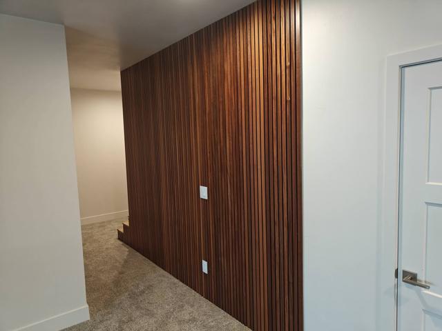 Custom sapele wood slat wall panel in the hallway