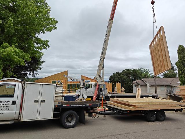 Crane lifting a prefabricated wall panel into place
