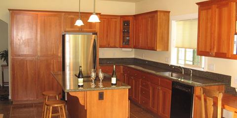 Kitchen with cherry cabinets and island