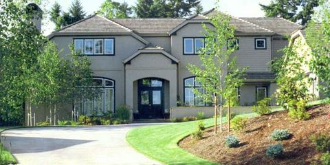 Two-story home with landscaped front yard