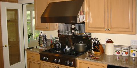 Kitchen with wood cabinets and range hood