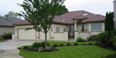 Single-story home with attached garage and lawn